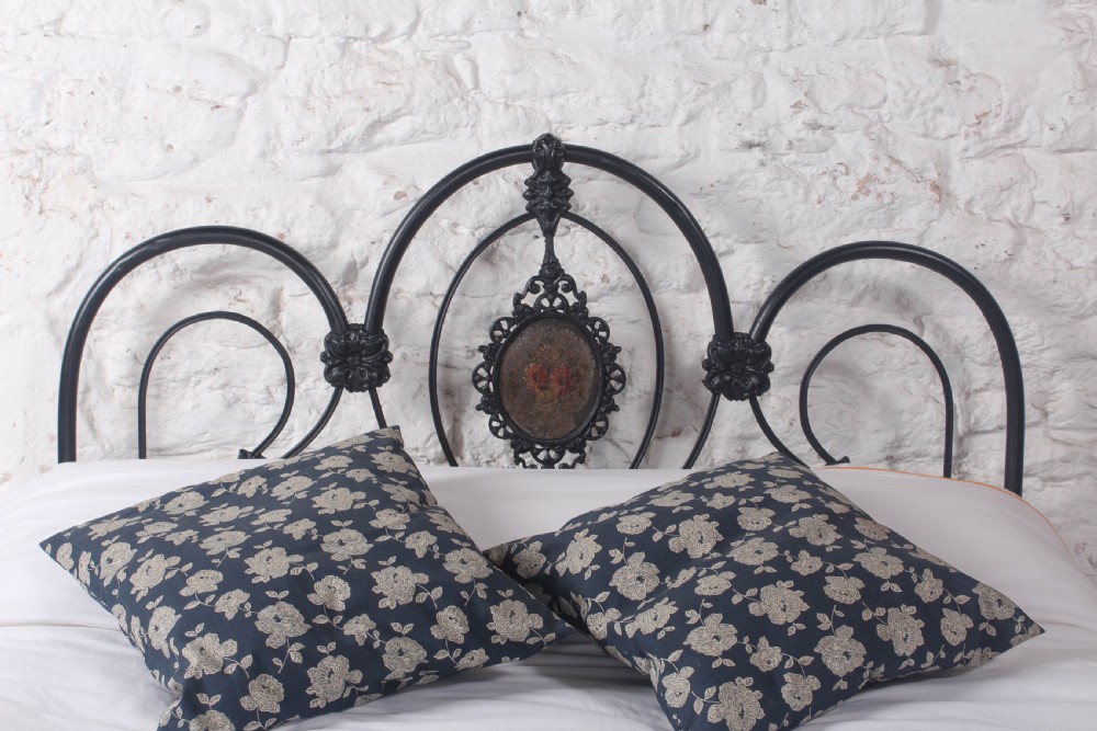 A Victorian black cast and wrought iron double bed frame featuring a three-hoop headboard and footboard with central decorative medallions. View VII