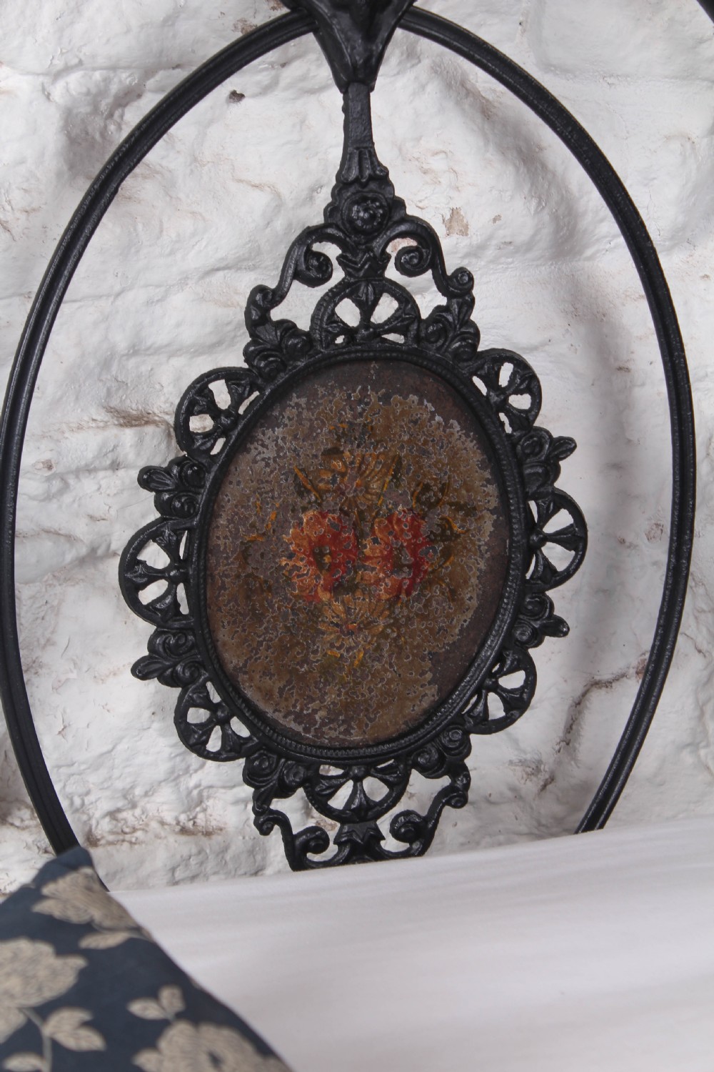 A Victorian black cast and wrought iron double bed frame featuring a three-hoop headboard and footboard with central decorative medallions. View IX
