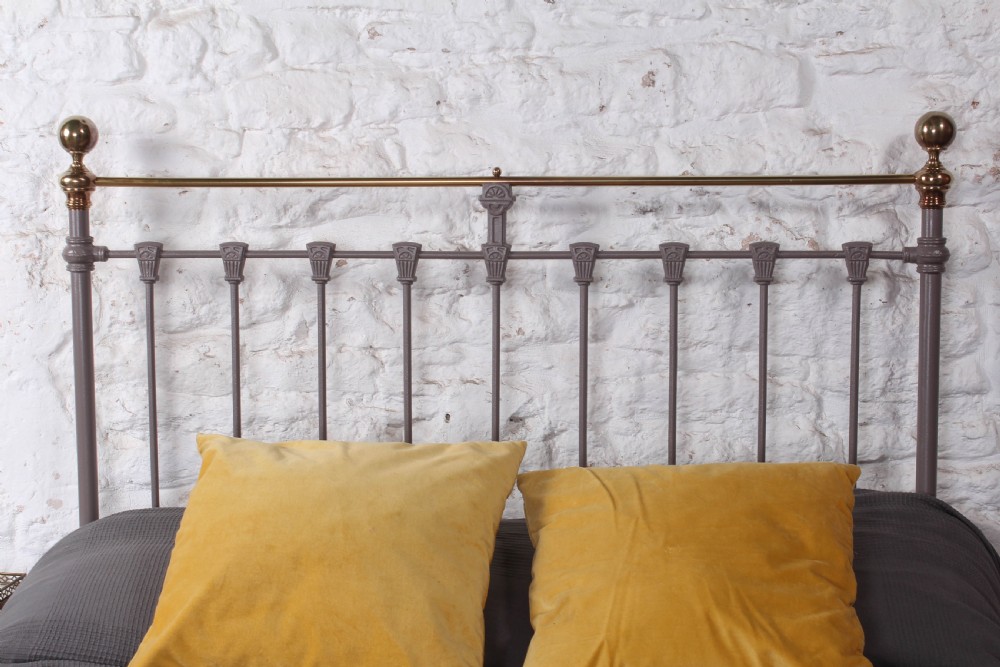 A Victorian double bed frame featuring a grey painted cast iron headboard with vertical spindles, a polished brass top rail, corner finials, and no footboard. View II