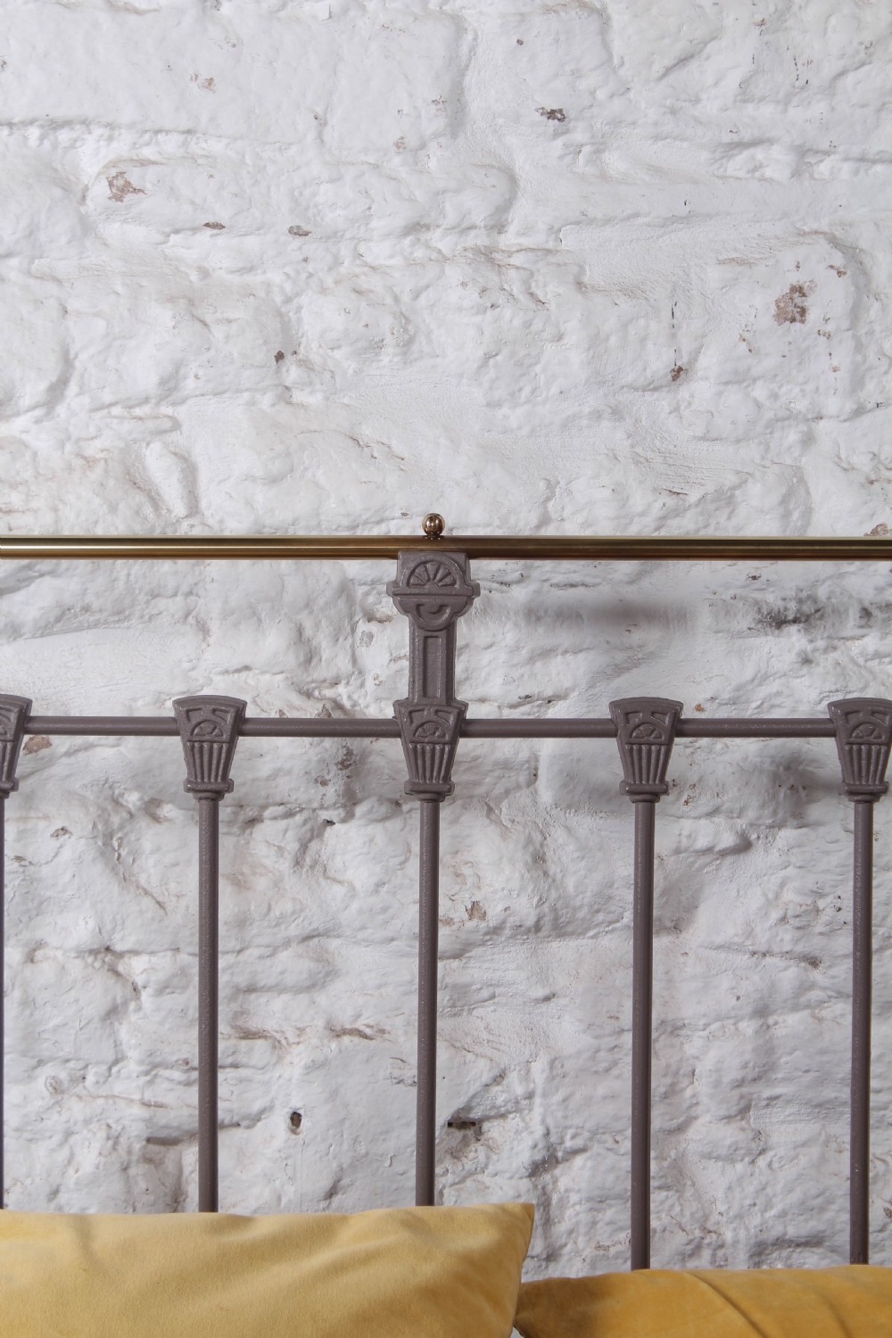 A Victorian double bed frame featuring a grey painted cast iron headboard with vertical spindles, a polished brass top rail, corner finials, and no footboard. View V