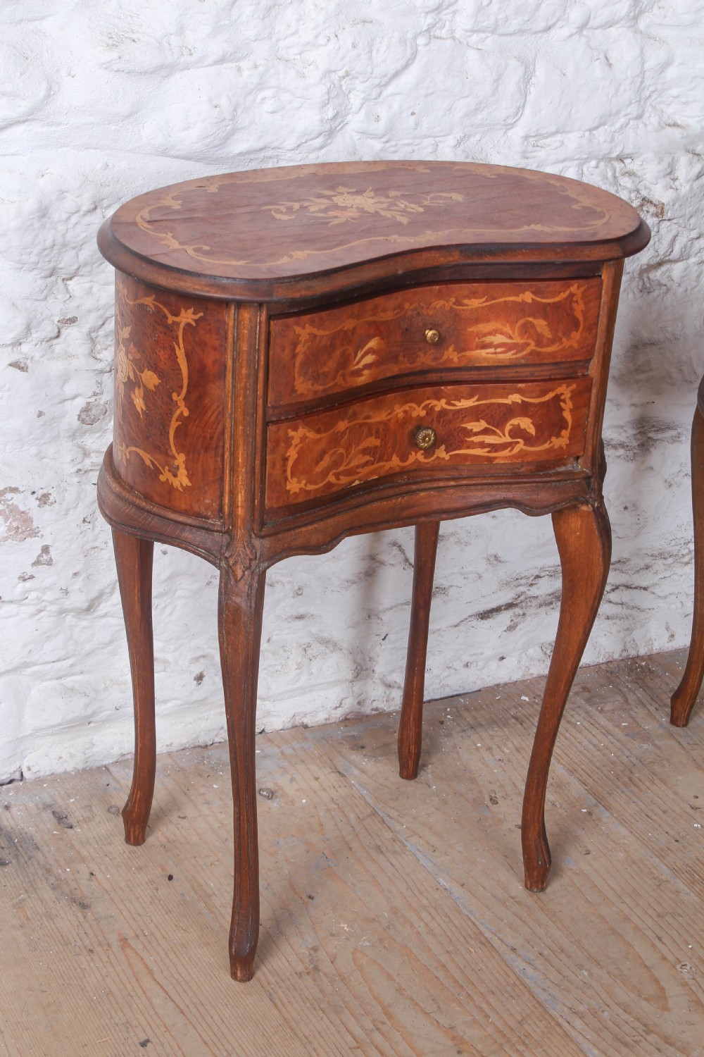 A pair of Louis XV style kidney-shaped bedside tables featuring floral marquetry inlays, two drawers, and slender cabriole legs. View IV