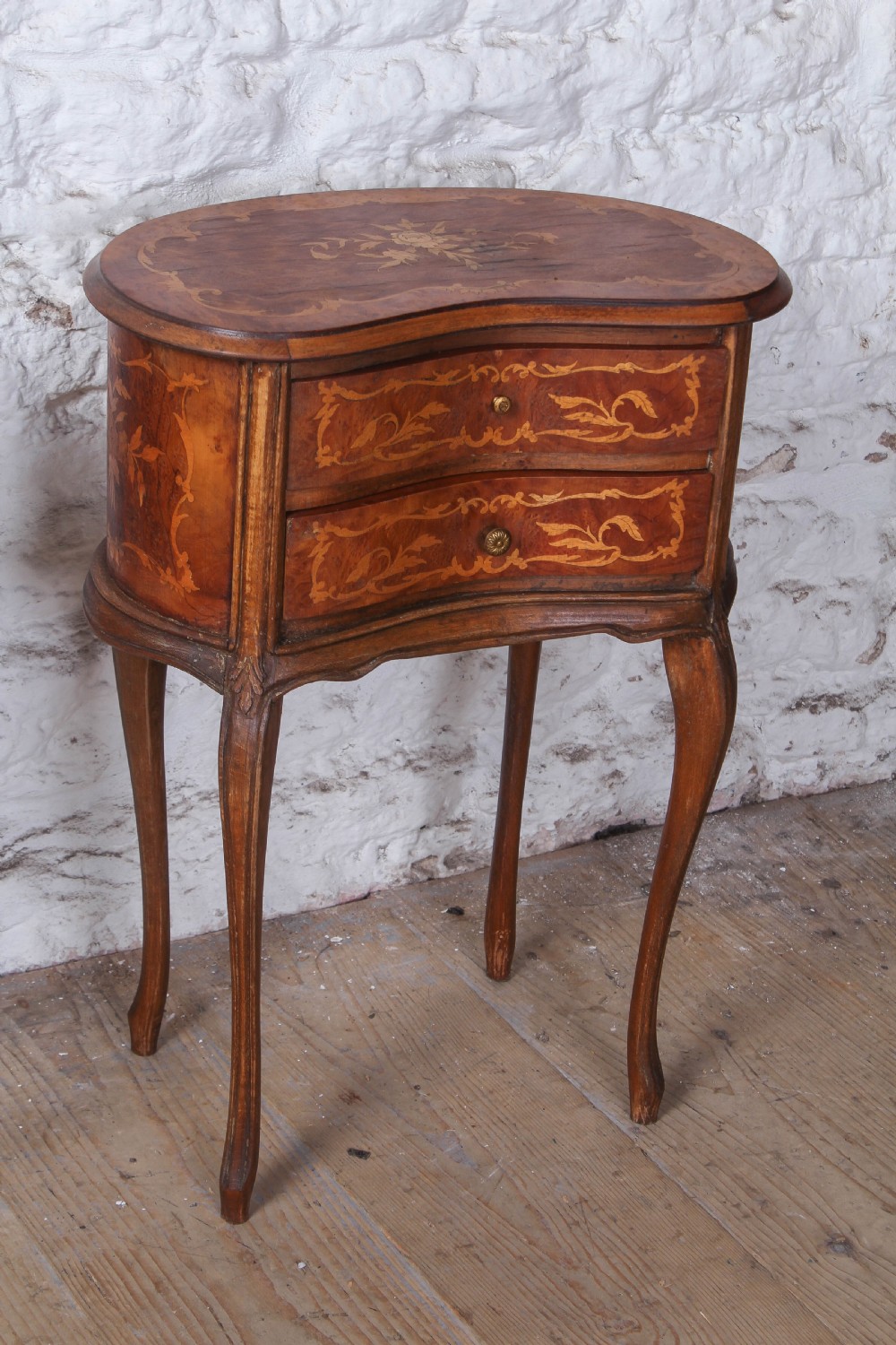 A pair of Louis XV style kidney-shaped bedside tables featuring floral marquetry inlays, two drawers, and slender cabriole legs. View V