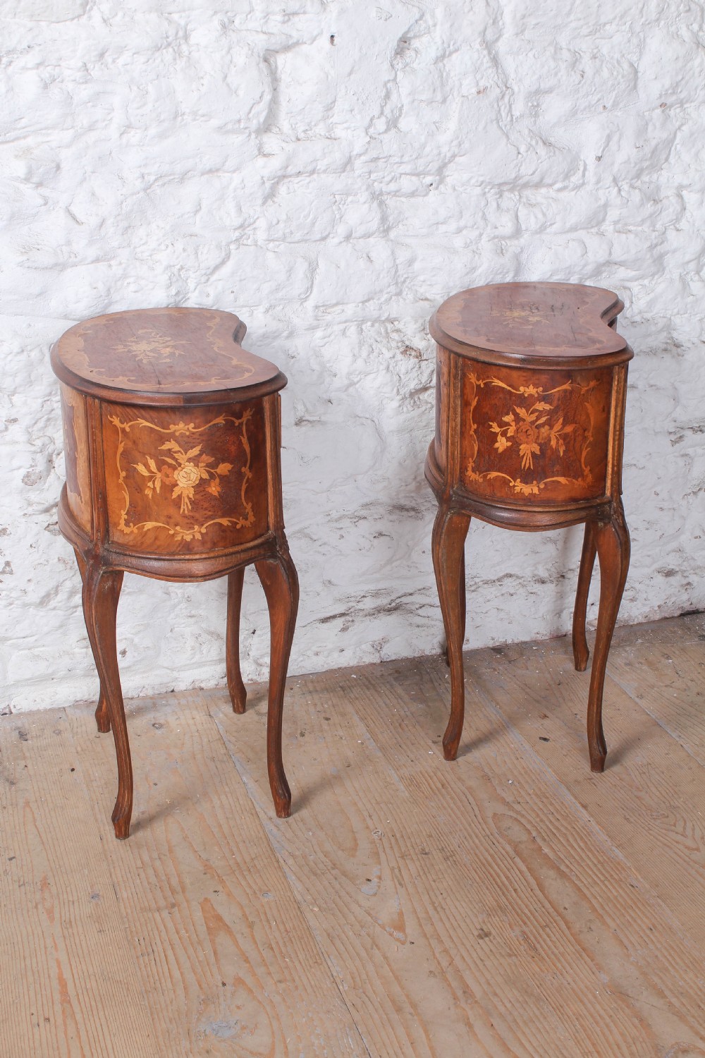 A pair of Louis XV style kidney-shaped bedside tables featuring floral marquetry inlays, two drawers, and slender cabriole legs. View VIII