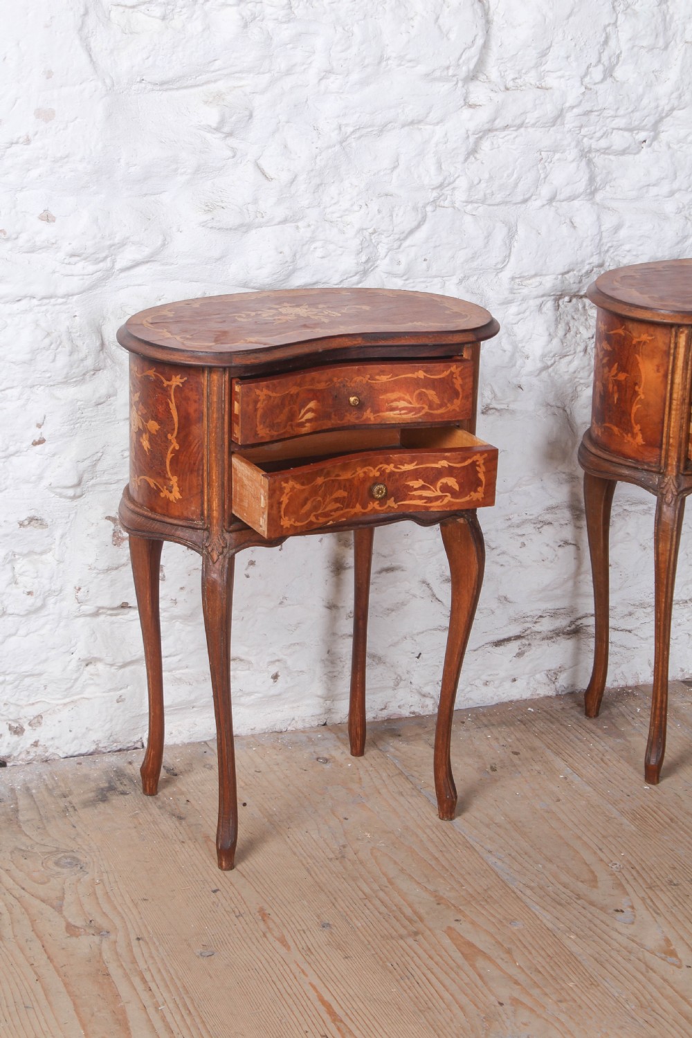 A pair of Louis XV style kidney-shaped bedside tables featuring floral marquetry inlays, two drawers, and slender cabriole legs. View IX