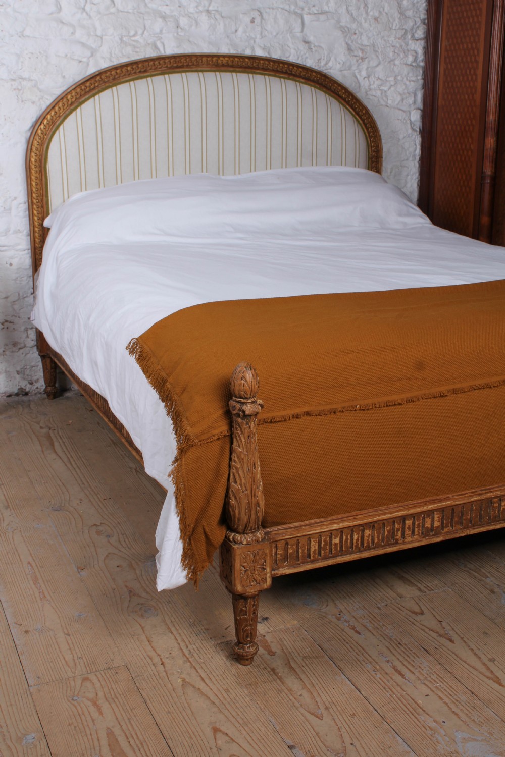 A Louis XVI style king size bed frame featuring a carved timber border, a striped upholstered arched headboard, and low carved corner posts. View III