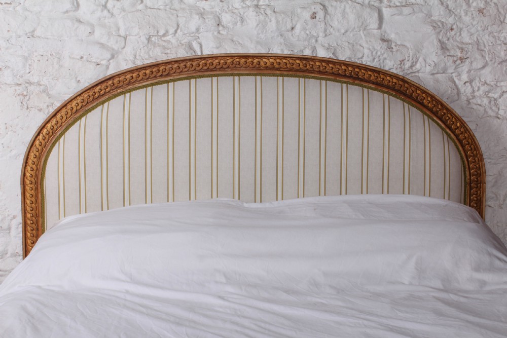 A Louis XVI style king size bed frame featuring a carved timber border, a striped upholstered arched headboard, and low carved corner posts. View IV
