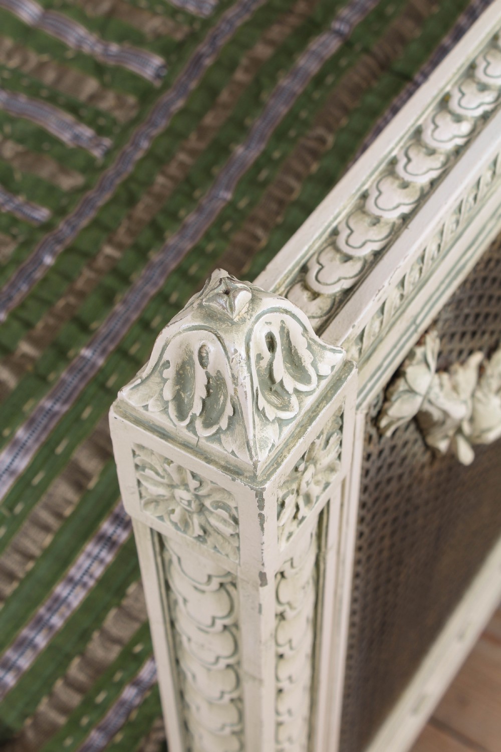 A painted Louis XVI style double bed frame featuring carved floral garlands, fluted corner posts, and woven cane panels in the headboard and footboard. View IV