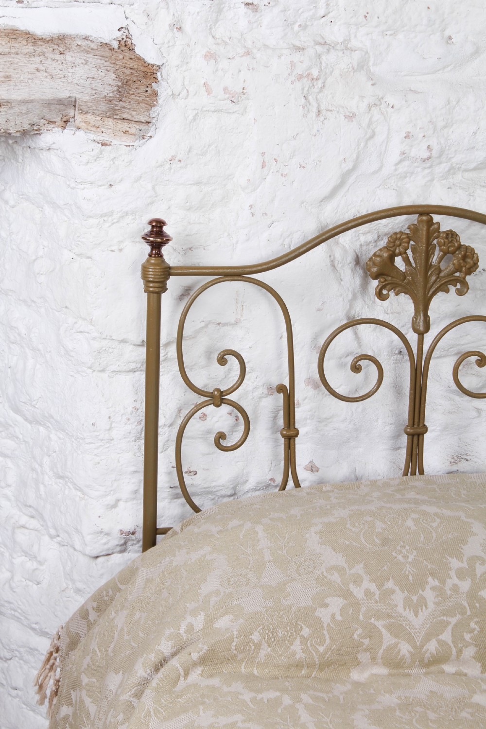 A pair of antique Portuguese small single metal beds featuring arched headboards with ornate metal scrollwork and central shell motifs. View IV