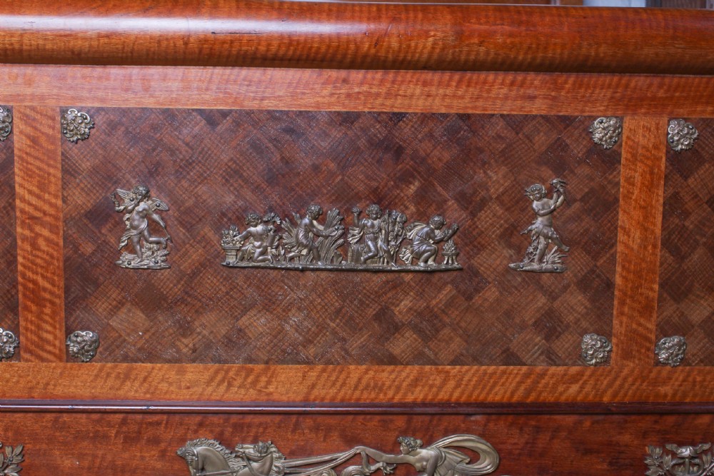 An Empire style mahogany double bedstead featuring rolled headboard profiles, parquetry panelwork, and decorative gilt-bronze mounts. View IX