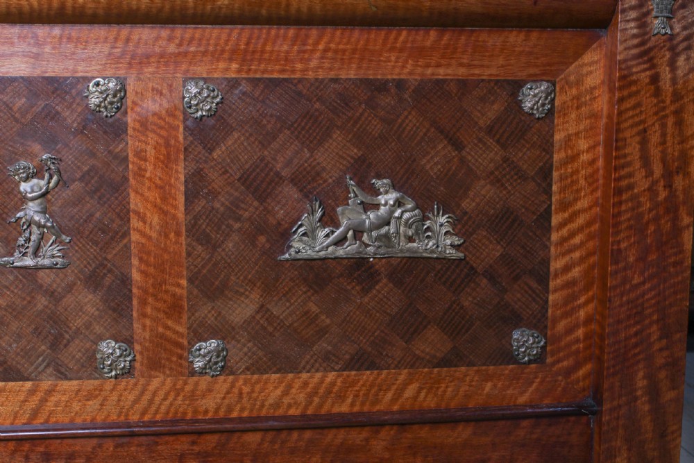 An Empire style mahogany double bedstead featuring rolled headboard profiles, parquetry panelwork, and decorative gilt-bronze mounts. View XI