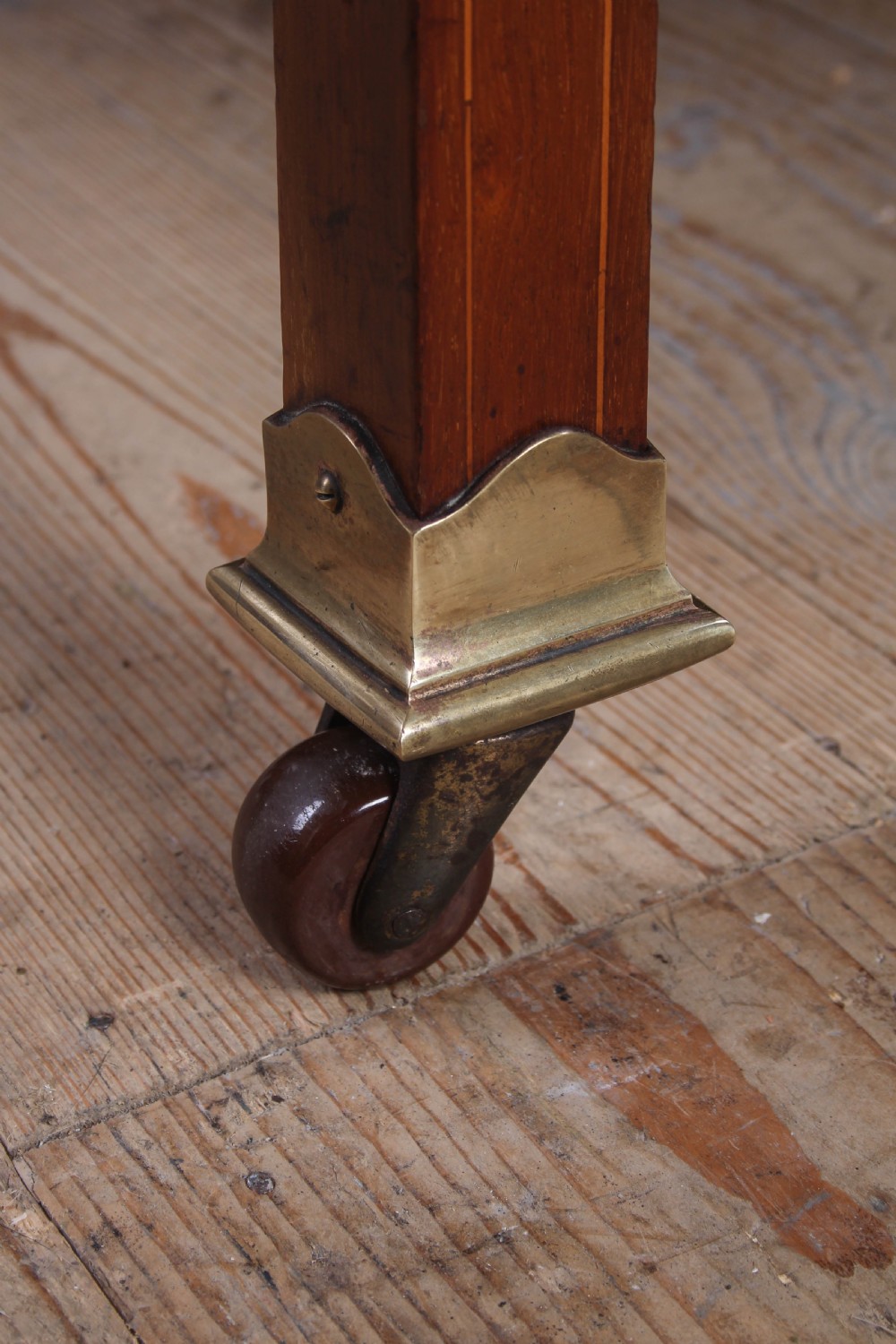 An antique mahogany double bed frame featuring polished brass upright spindles, brass urn finials, and an oval marquetry medallion inlaid on the footboard. View VI