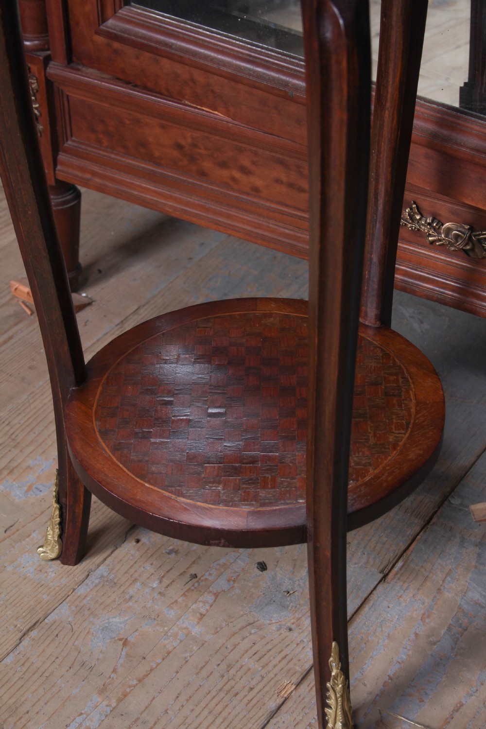 A small, round Louis XV style mahogany side table featuring a brass gallery rim, a single frieze drawer, slender cabriole legs with brass feet, and a lower parquetry shelf. View III