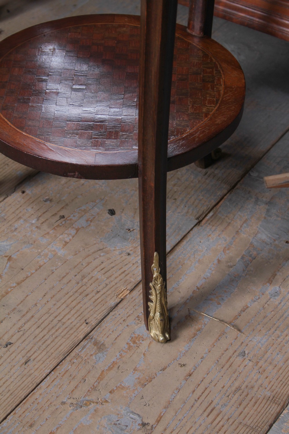 A small, round Louis XV style mahogany side table featuring a brass gallery rim, a single frieze drawer, slender cabriole legs with brass feet, and a lower parquetry shelf. View IV