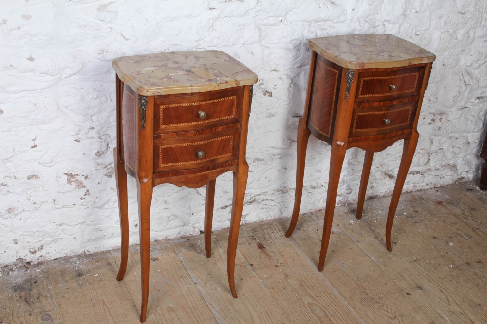 A pair of slender French wooden bedside tables featuring variegated marble tops, two inlaid drawers, and high cabriole legs. View II