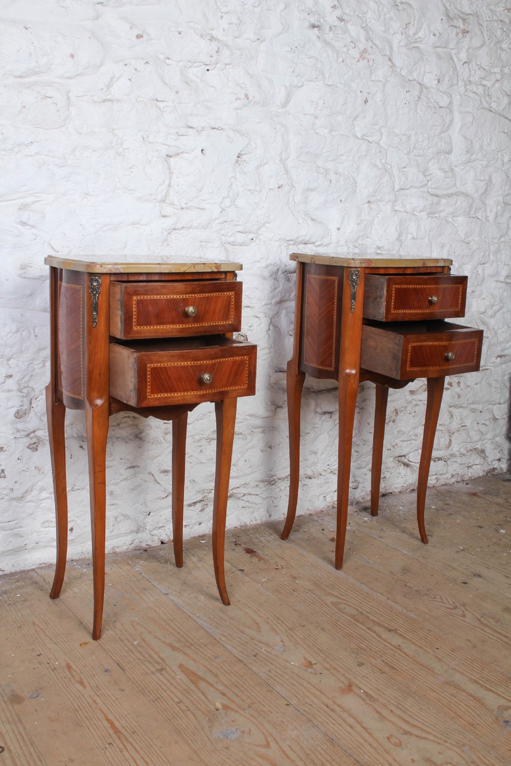 A pair of slender French wooden bedside tables featuring variegated marble tops, two inlaid drawers, and high cabriole legs. View III