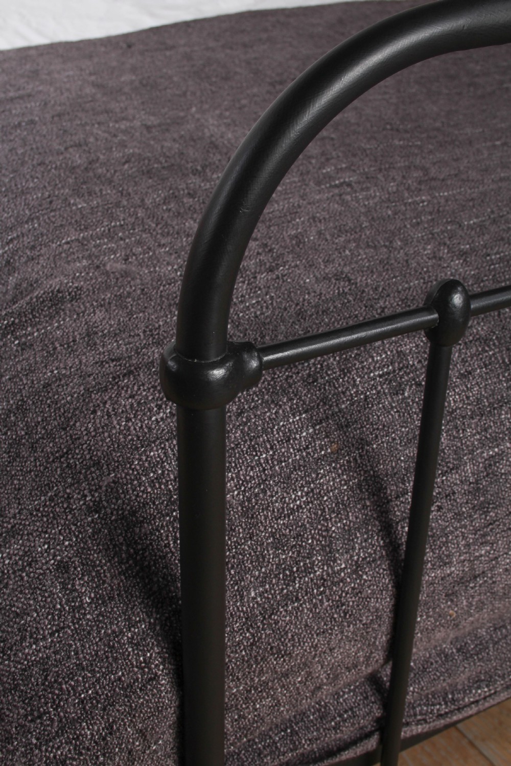 A black painted iron double bed frame featuring a vertical spindle headboard and matching footboard. View V
