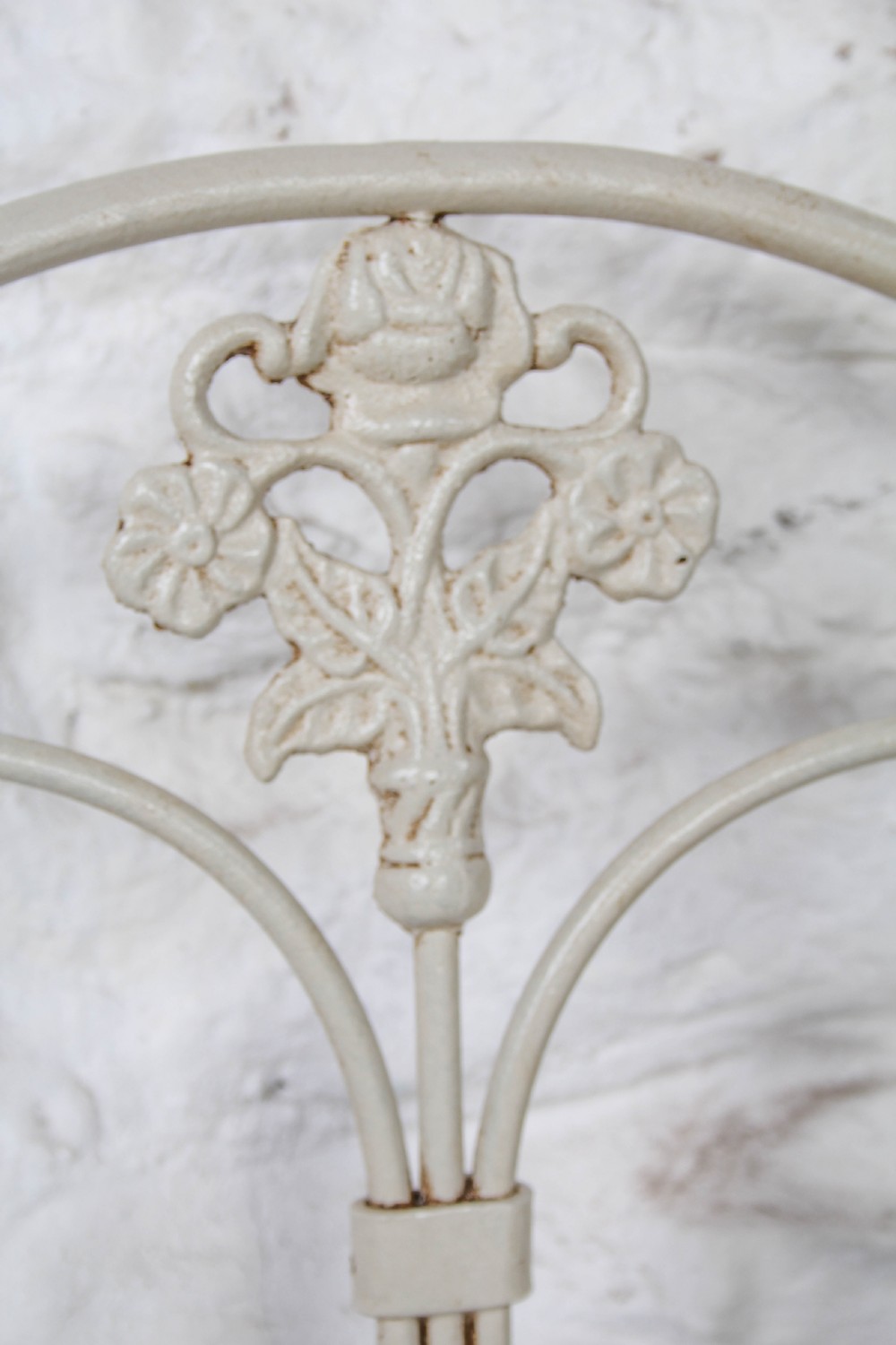 A pair of cream-painted antique Portuguese iron single beds featuring decorative scrolled headboards and low-profile foot ends. View IV