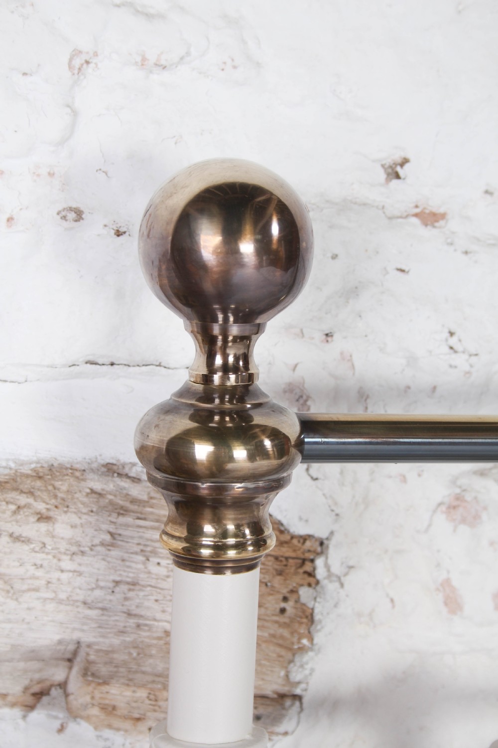 A pair of white painted Victorian single bed frames with vertical iron spindles and brass top rails. View III