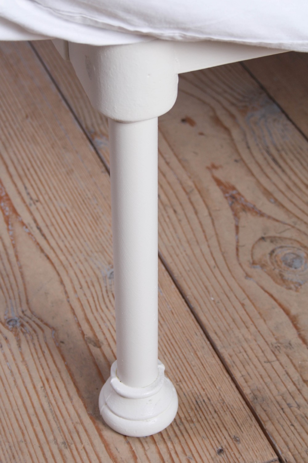 A pair of white painted Victorian single bed frames with vertical iron spindles and brass top rails. View IV
