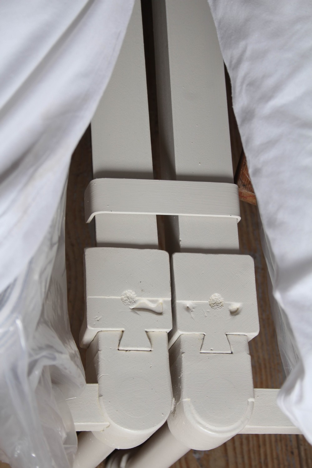 A pair of white painted Victorian single bed frames with vertical iron spindles and brass top rails. View VII