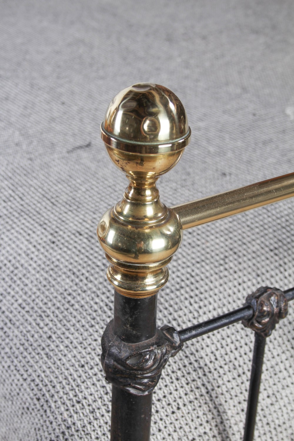 A Victorian five-foot king-size bedstead featuring a black japanned cast iron frame with vertical arched spindles, central diamond motifs, and brass top rails with brass finials. View IX