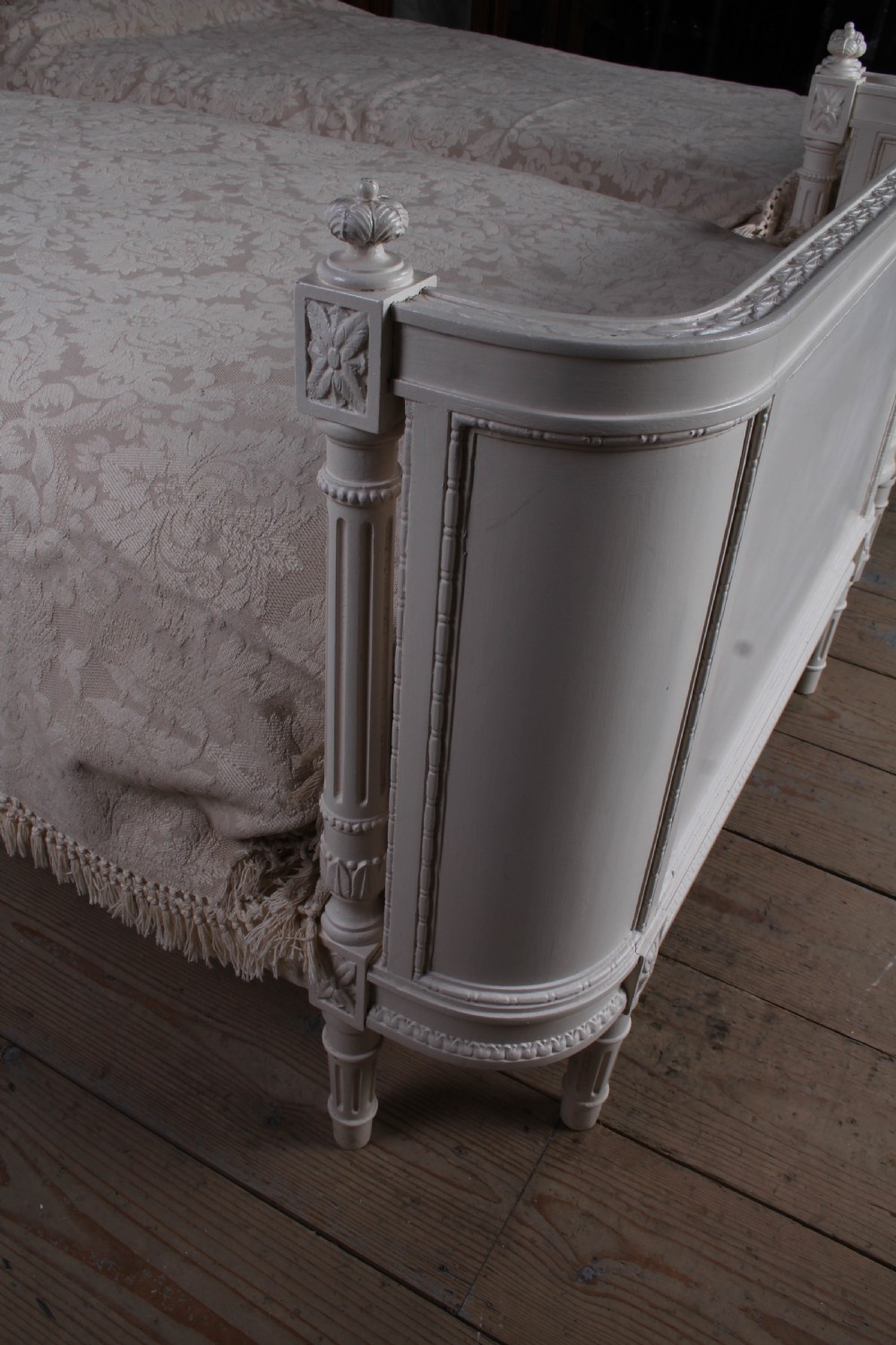 A pair of off-white painted French corbeille single bed frames featuring curved footboards, carved details, and fluted legs. View VIII