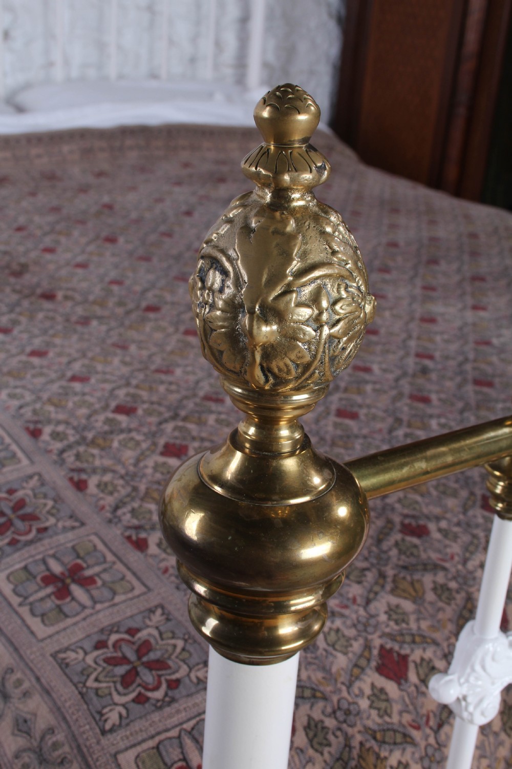 A Victorian white painted iron bedstead featuring brass top rails and brass urn finials on the headboard and footboard. View IV