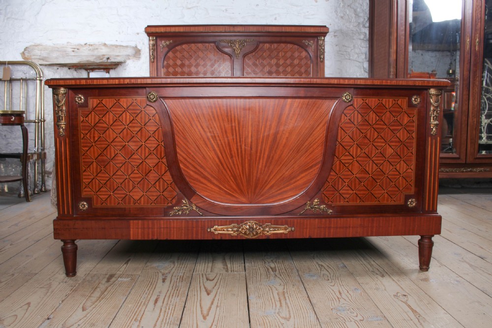 A French Empire style king size bed frame crafted from mahogany with diamond geometric fruitwood parquetry inlays and decorative brass mounts. View IV