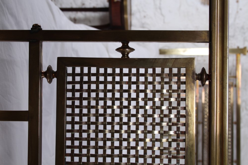 An antique French brass double bed frame with ornamental lattice headboard and footboard panels, vertical spindles, and finial corner posts. View XXIII