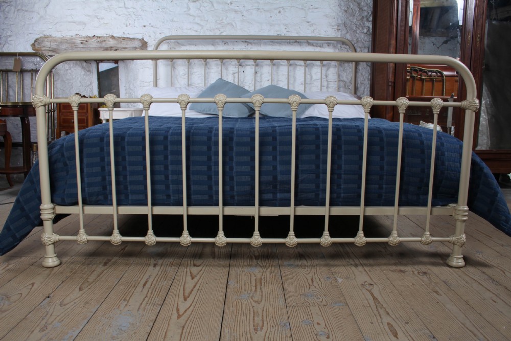 A cream-painted French iron super king size bed frame featuring vertical spindles and cast iron ornamental details. View V
