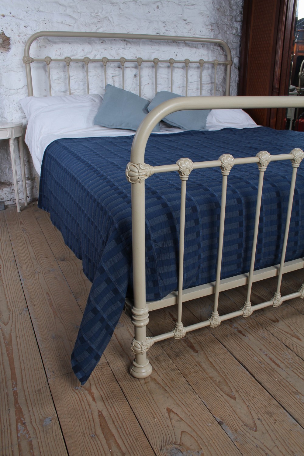 A cream-painted French iron super king size bed frame featuring vertical spindles and cast iron ornamental details. View VII