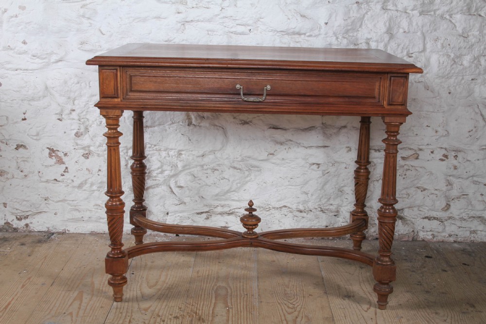 A Louis XVI style fruitwood table featuring a single frieze drawer with brass handle, turned fluted legs, and an X-frame stretcher with a central finial. View III
