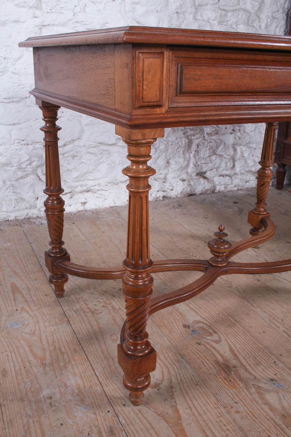 A Louis XVI style fruitwood table featuring a single frieze drawer with brass handle, turned fluted legs, and an X-frame stretcher with a central finial. View VI