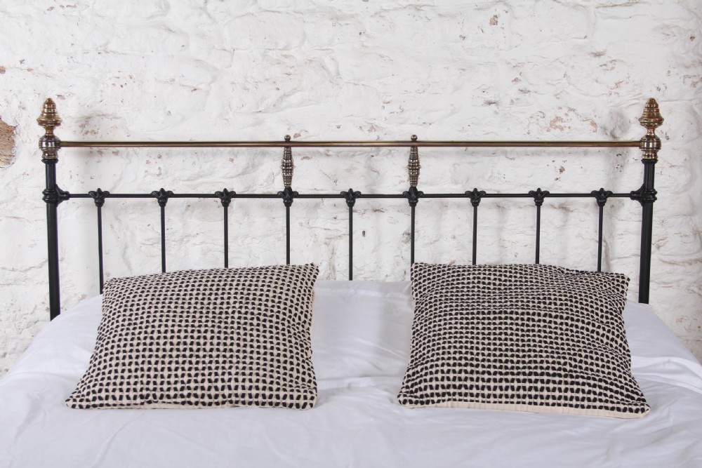 A Victorian black iron king-size bed frame featuring vertical headboard spindles, a brass top rail, decorative brass finials, and a low foot end. View II