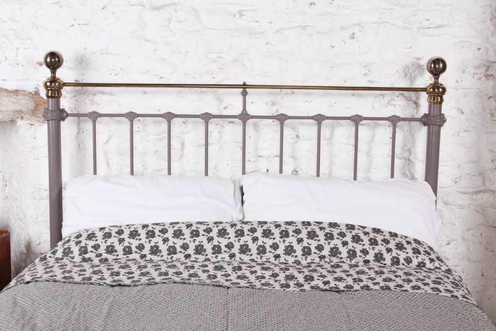 A Victorian cast iron and brass king size bedstead featuring vertical spindles, decorative brass finials, and a grey painted frame. View IV