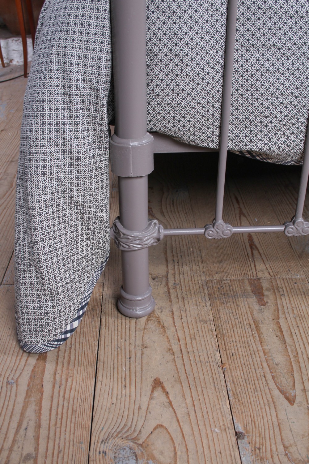 A Victorian cast iron and brass king size bedstead featuring vertical spindles, decorative brass finials, and a grey painted frame. View VI