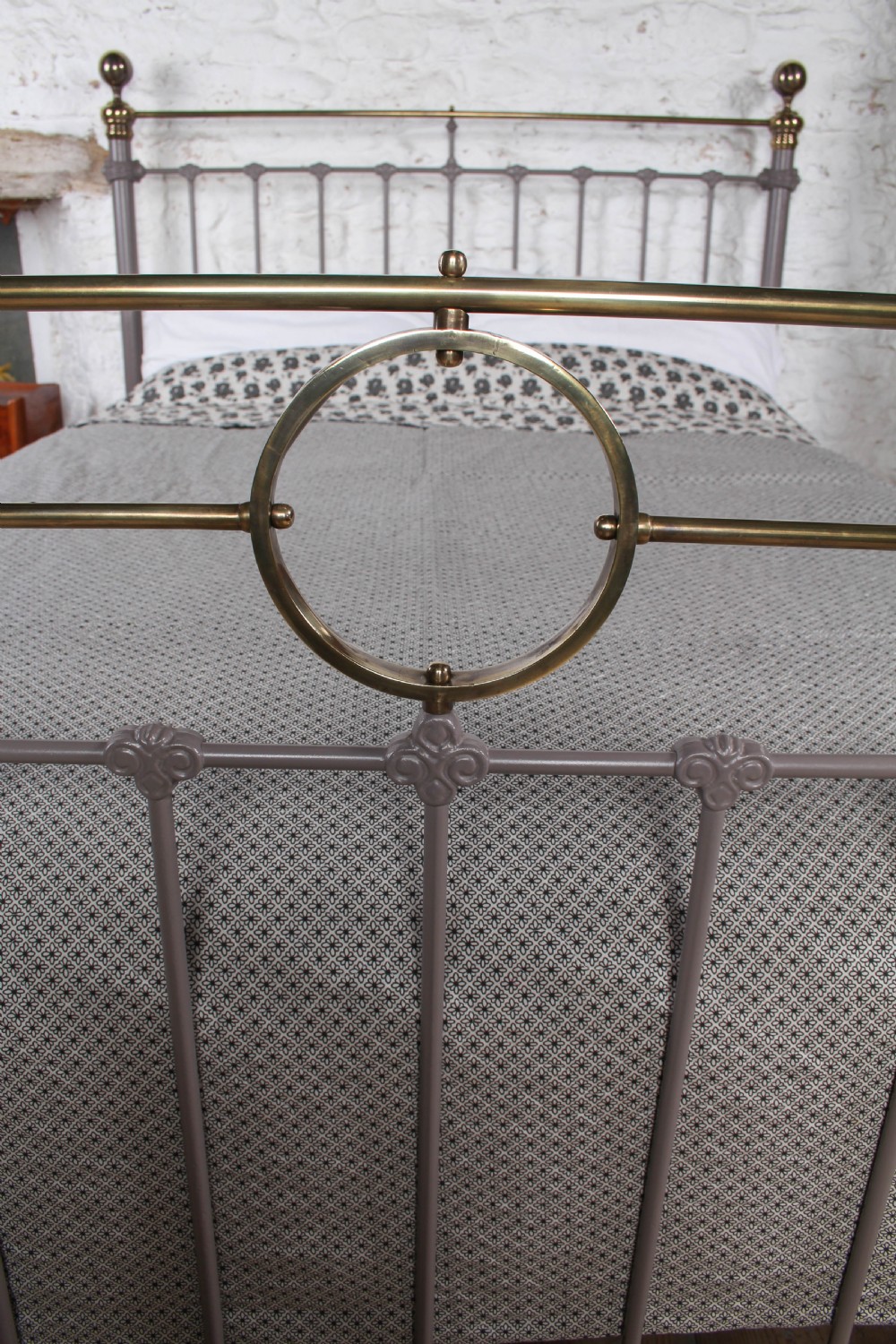 A Victorian cast iron and brass king size bedstead featuring vertical spindles, decorative brass finials, and a grey painted frame. View VII
