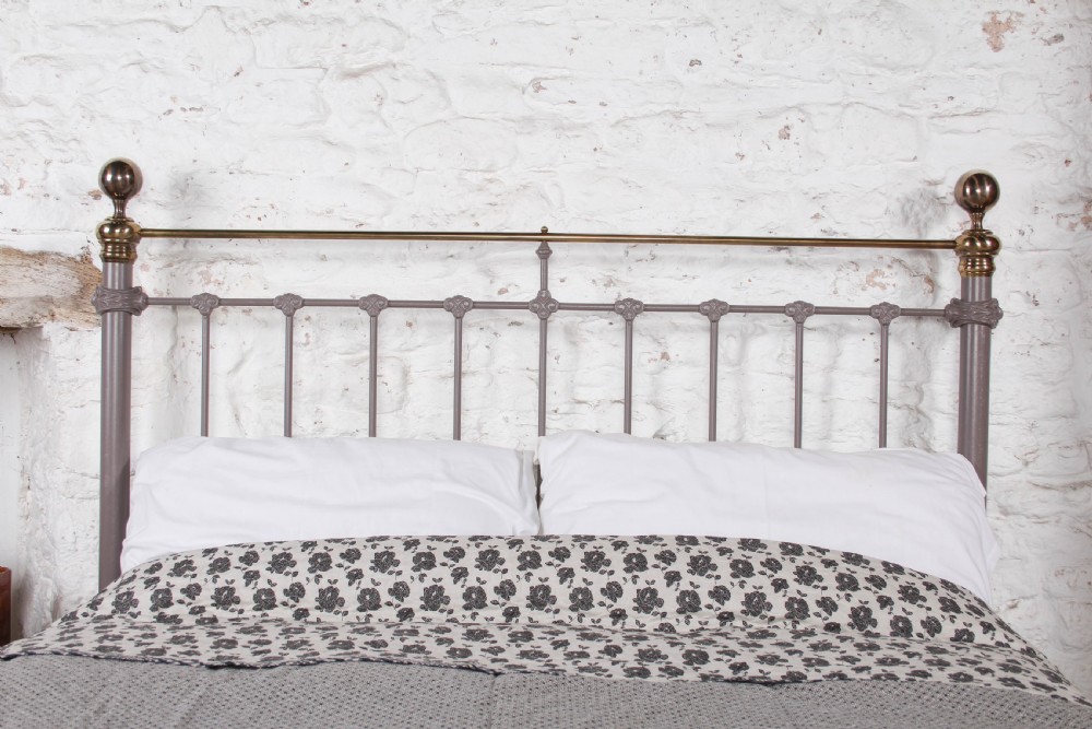 A Victorian cast iron and brass king size bedstead featuring vertical spindles, decorative brass finials, and a grey painted frame. View VIII