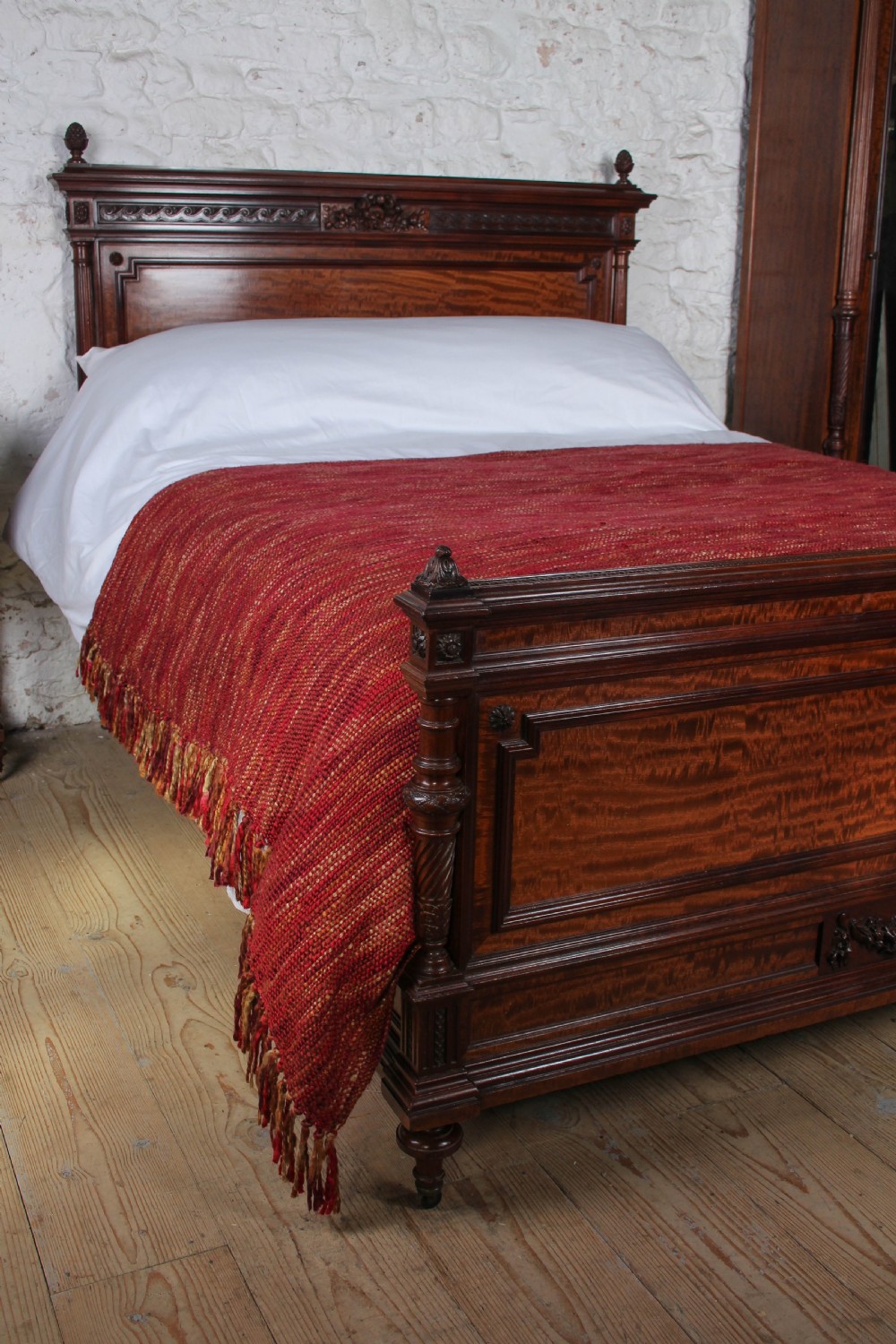 A French Louis XVI style carved mahogany king size bedstead with flame mahogany panelled footboard. View V
