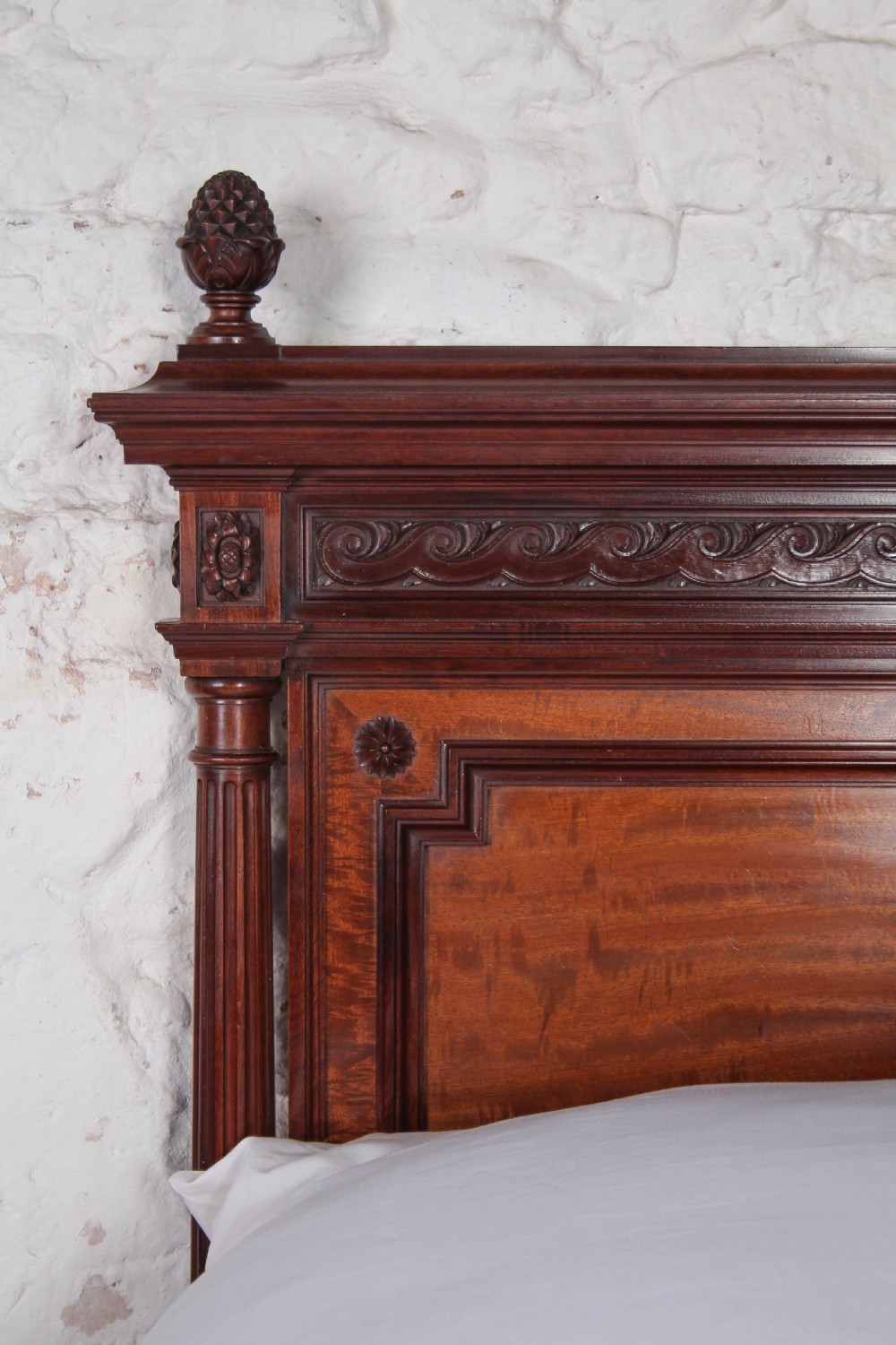 A French Louis XVI style carved mahogany king size bedstead with flame mahogany panelled footboard. View VI