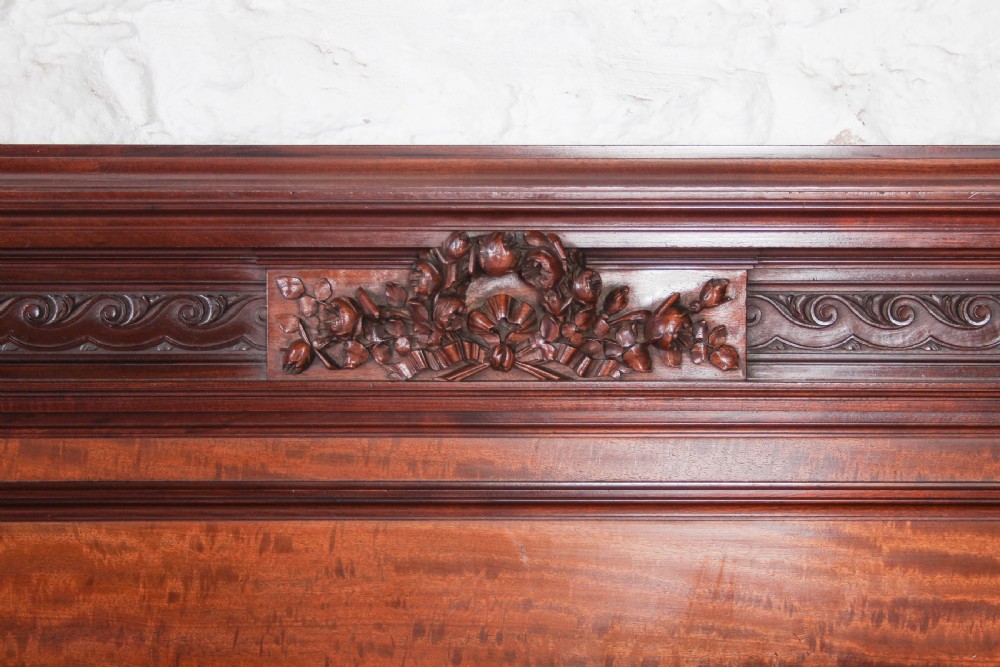 A French Louis XVI style carved mahogany king size bedstead with flame mahogany panelled footboard. View IX
