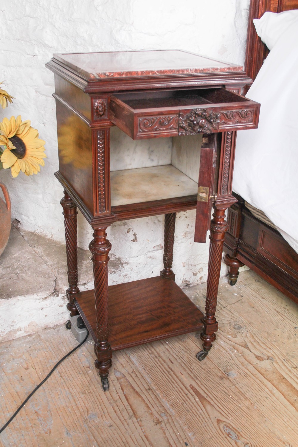 A French Louis XVI style carved mahogany king size bedstead with flame mahogany panelled footboard. View X