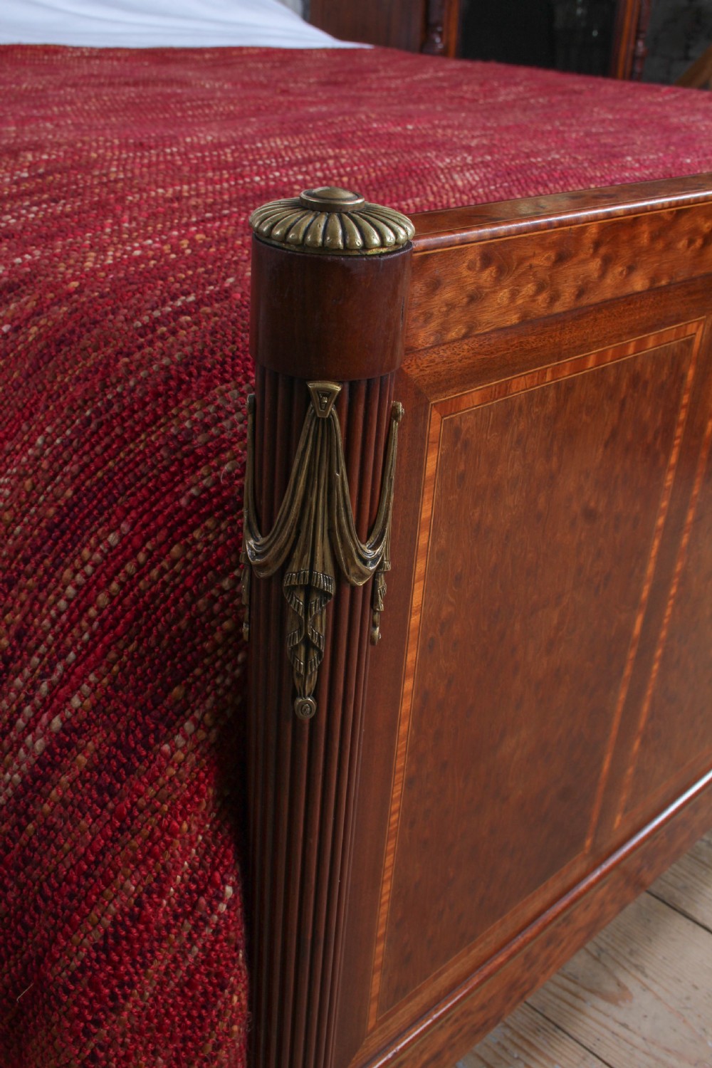 An antique French mahogany king-size bed frame featuring inlaid wood borders, decorative brass mounts, and fluted corner posts. View III