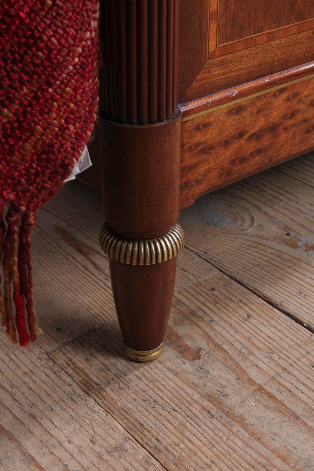 An antique French mahogany king-size bed frame featuring inlaid wood borders, decorative brass mounts, and fluted corner posts. View IX