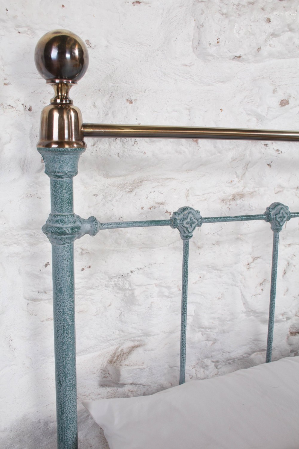 A Victorian king-size light blue painted iron bedstead featuring a straight brass top rail with polished brass corner finials. View III
