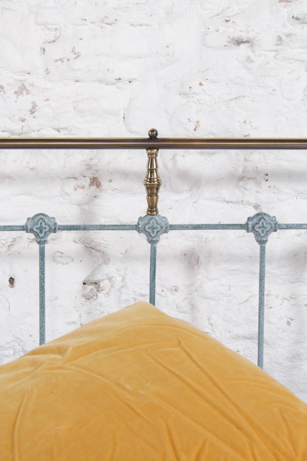 A Victorian king-size light blue painted iron bedstead featuring a straight brass top rail with polished brass corner finials. View VI