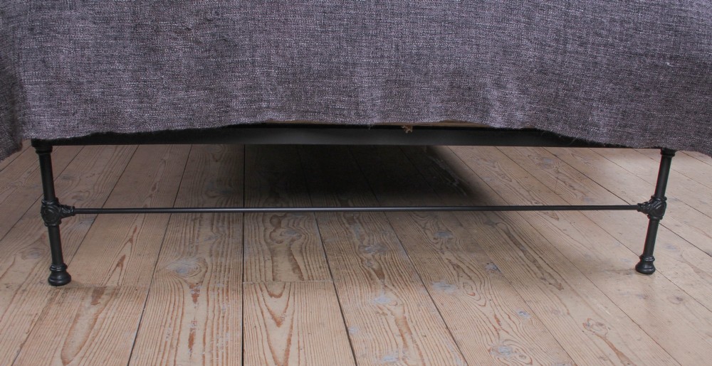 A Victorian Art Nouveau style black cast iron king size bed frame featuring vertical spindles and decorative joinery details. View II