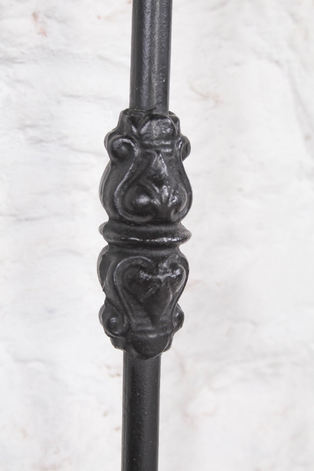 A Victorian Art Nouveau style black cast iron king size bed frame featuring vertical spindles and decorative joinery details. View X
