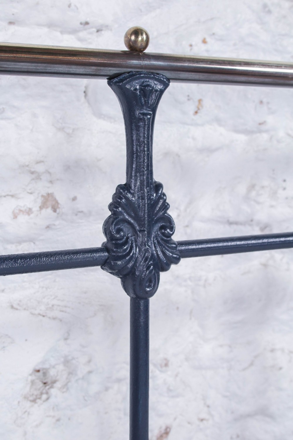 A Victorian double bed frame featuring a dark cast iron headboard with vertical spindles and a polished brass top rail with corner finials. View III