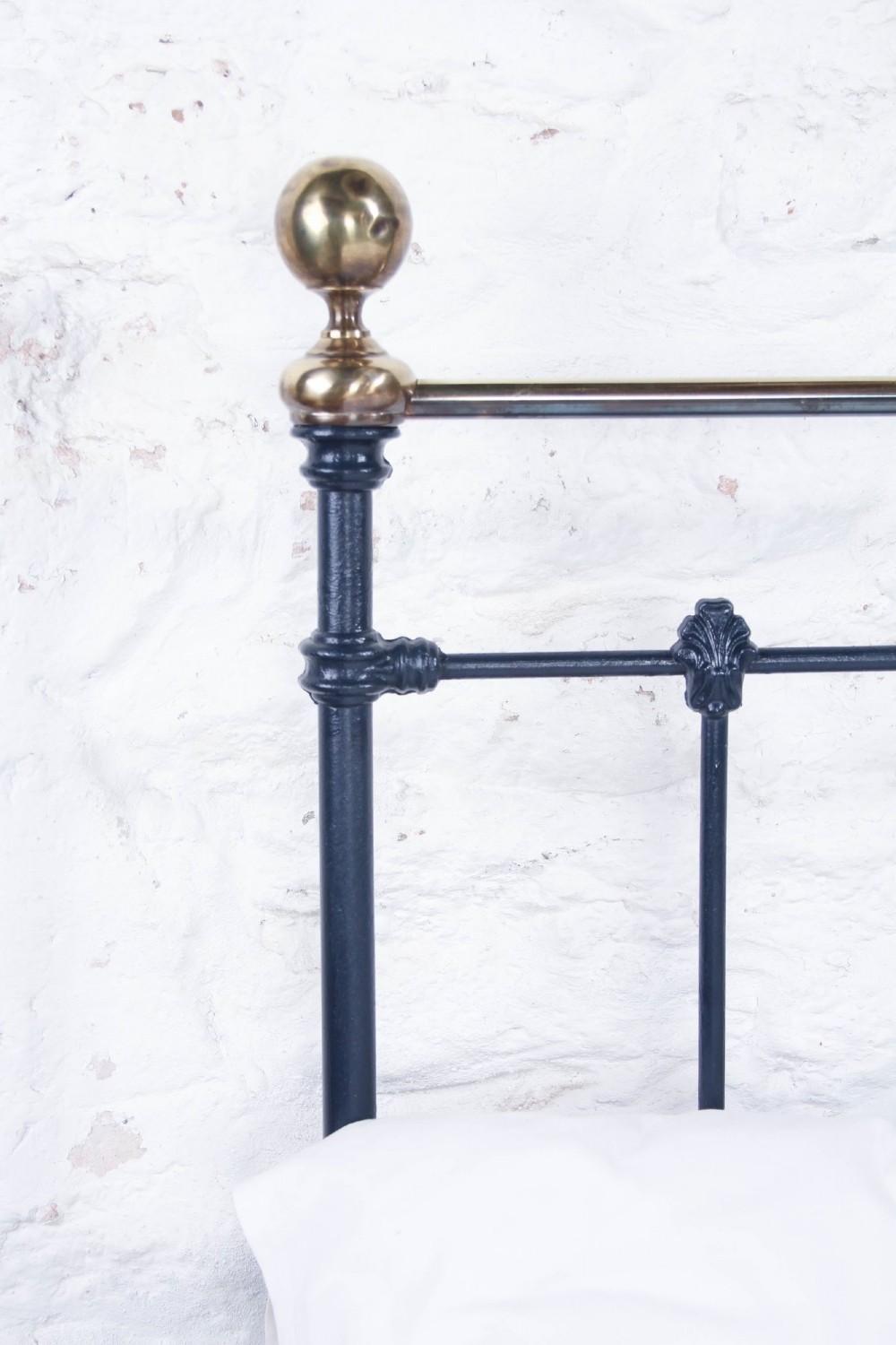 A Victorian double bed frame featuring a dark cast iron headboard with vertical spindles and a polished brass top rail with corner finials. View IV